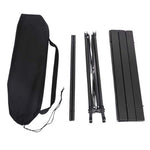 Side view of black camping table on grass or campsite